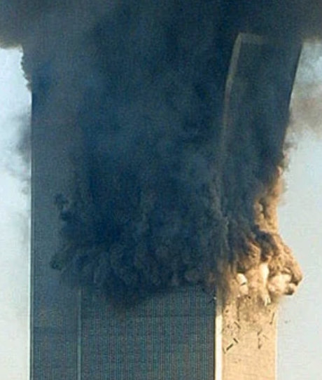 WTC2 upper section tilting and expanding outward into spherical aerosol configuration, showing rapid loss of structural cohesion